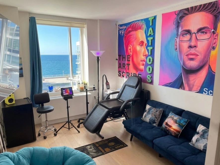 The Art Scribe's private Brooklyn tattoo studio with modern furnishings, original artwork and an ocean view